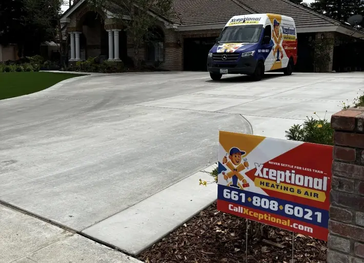 Branded HVAC service vehicle parked at a residential job site