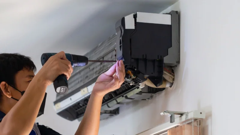 HVAC technician installing or repairing a residential air conditioning system