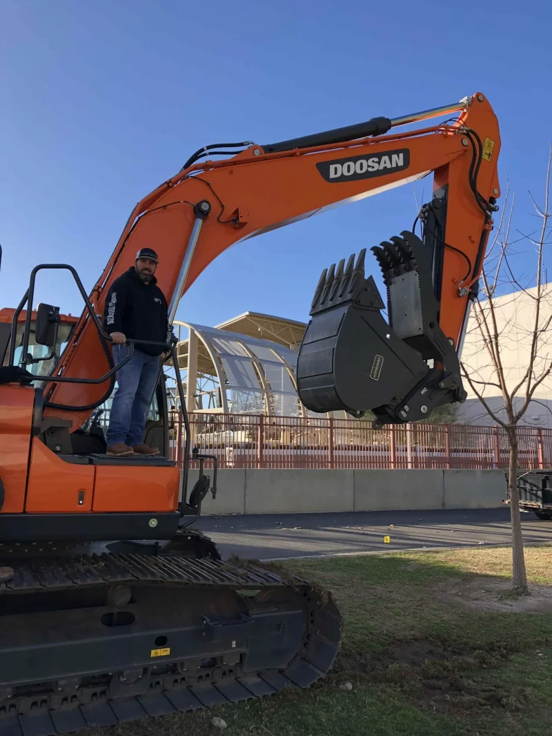 Excavation work in progress with heavy equipment for underground plumbing