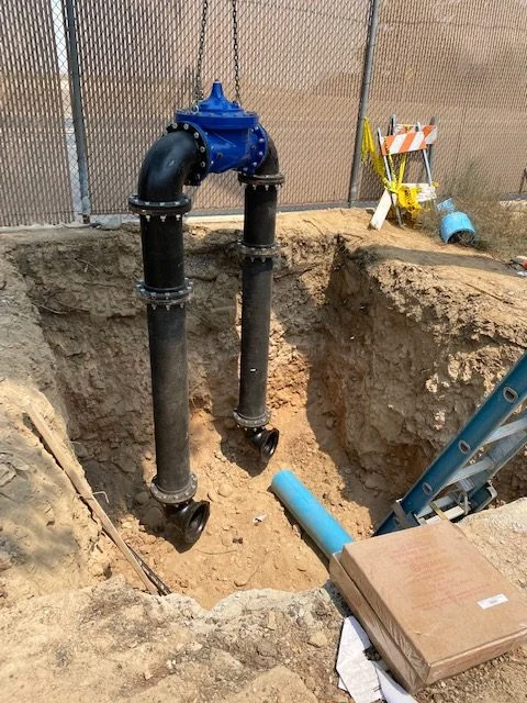 Exposed underground water pipes during trench excavation