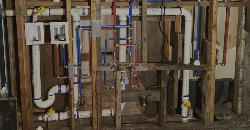 Repiping project in progress with exposed plumbing lines