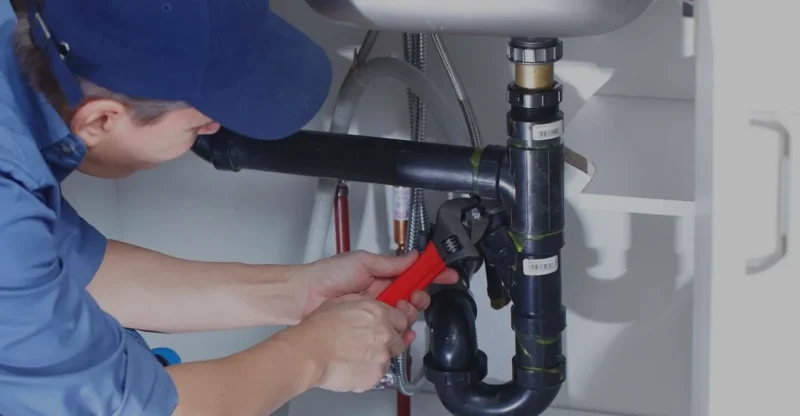Technician working on sewer and drain pipe system