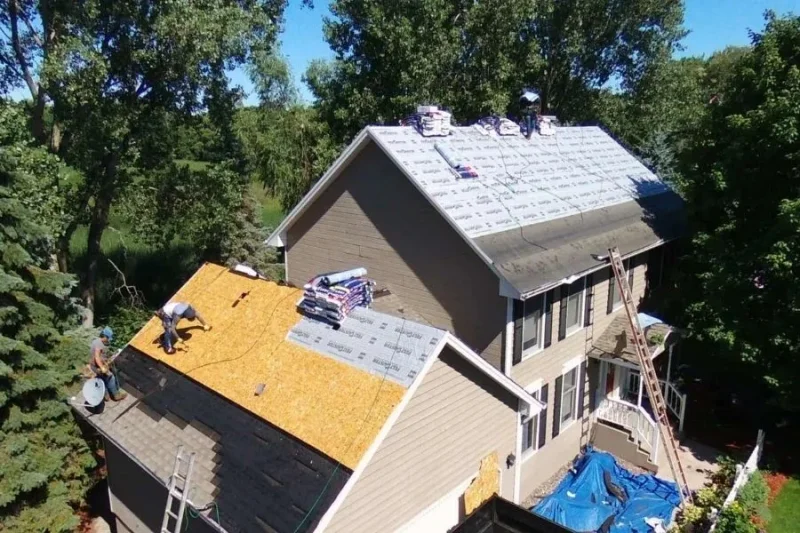 Technicians working on a residential roofing project