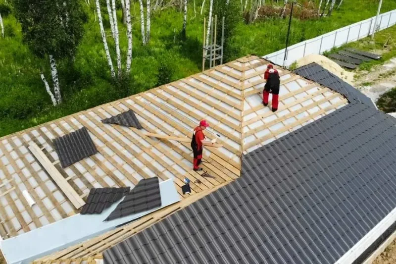 Technicians installing a new roof on a residential property