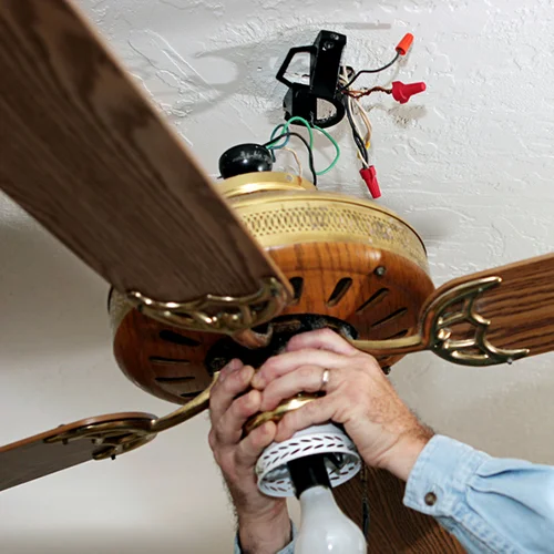 Technician installing a ceiling fan