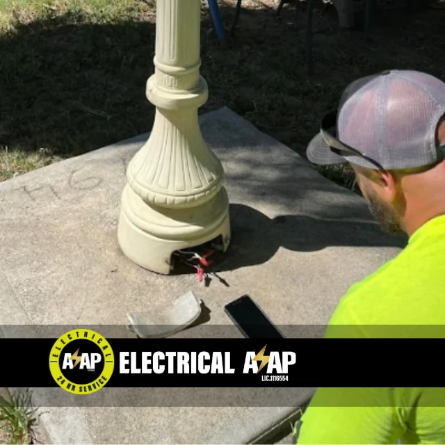 Technician installing indoor lighting fixture