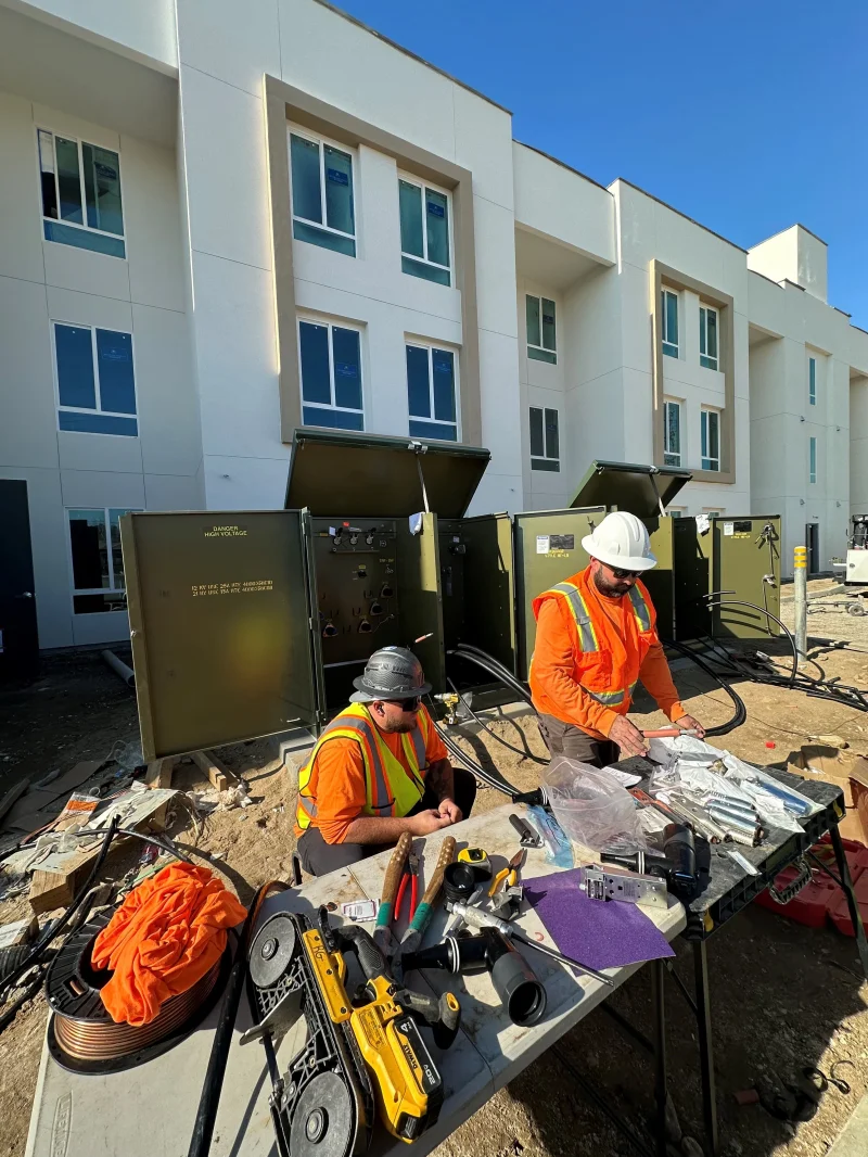 Technicians working on an electrical transformer system