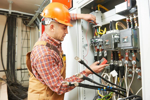 Technician performing electrical installation or repair work