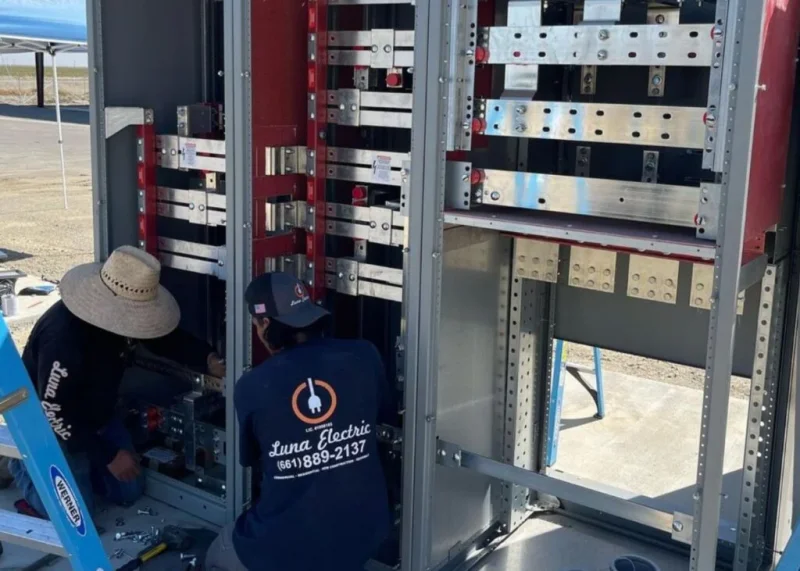 Technician performing commercial electrical installation work