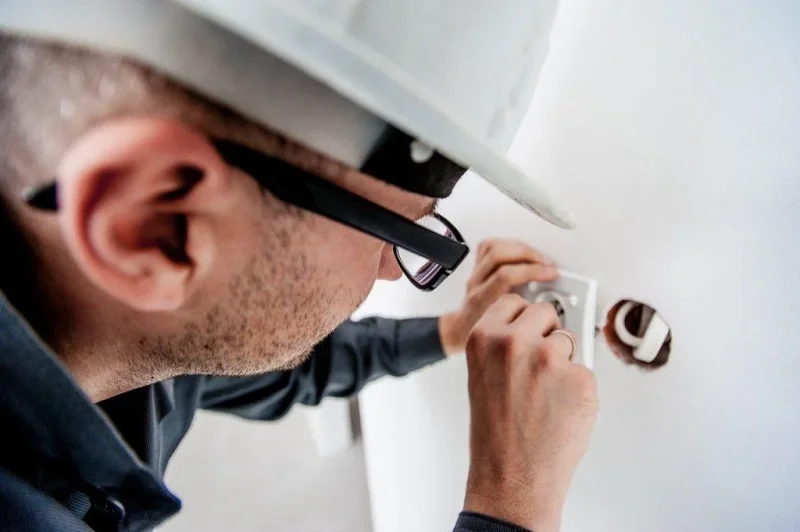Technician performing electrical installation or repair work